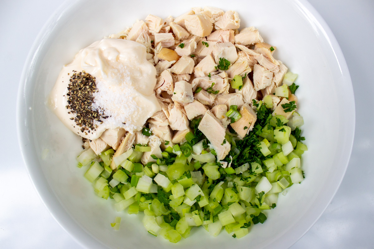 all chicken salad ingredients in bowl not yet mixed