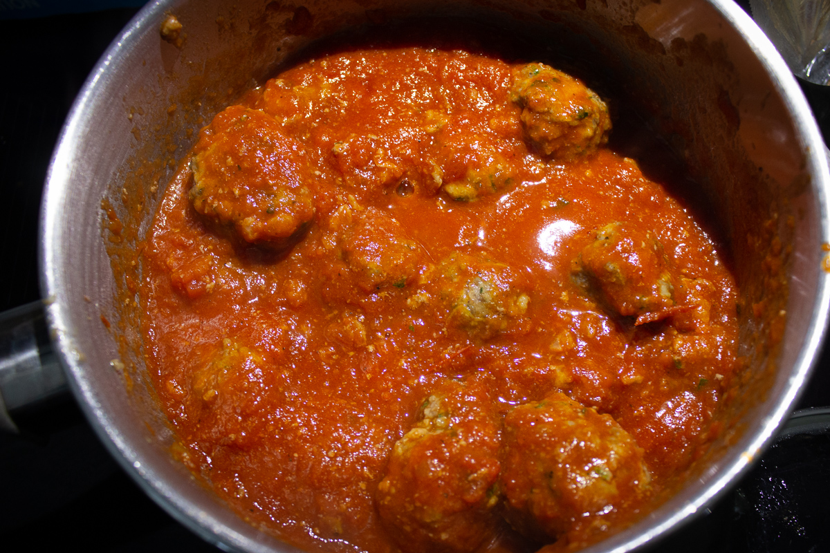 meatballs simmering in pot on stove