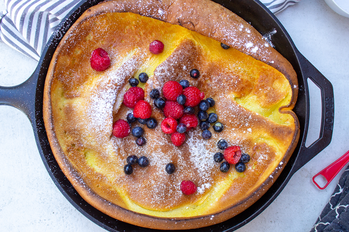 dutch pancaked puffed oven in skillet with berries on top