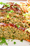 sliced chicken meatloaf with coleslaw on plate p