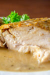 piece of IP roasted chicken with gravy on plate p