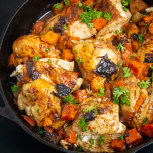 moroccan chicken pieces in skillet with potatoes