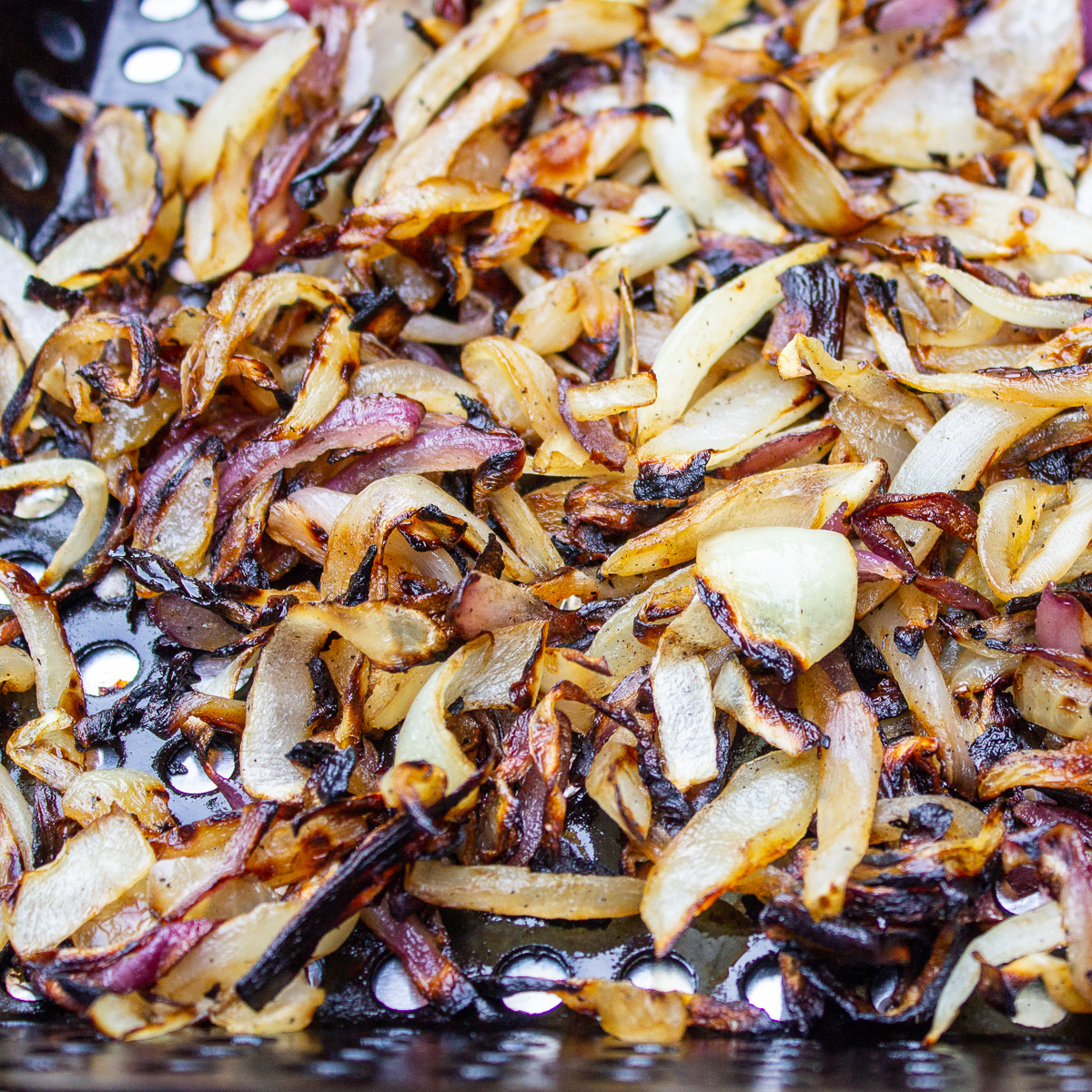 charred onions in grill basket