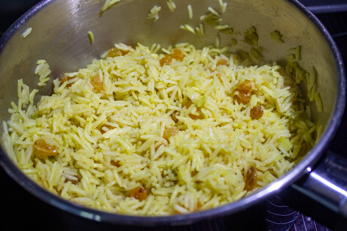 curried rice with raisins in pot