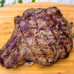 grilled rib steak on cutting board