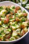 bowl of herbed potato salad on table p