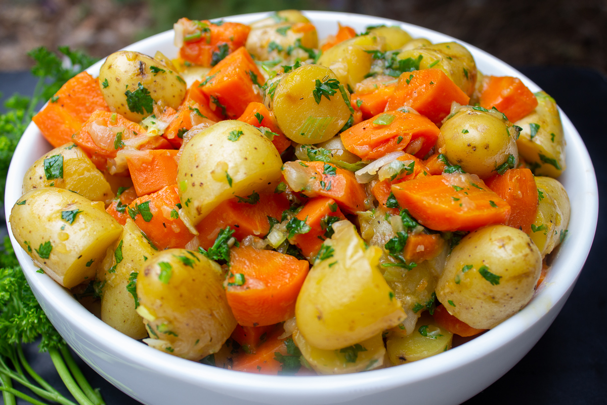 bowl of cooked potatoes and carrots with herbs 2