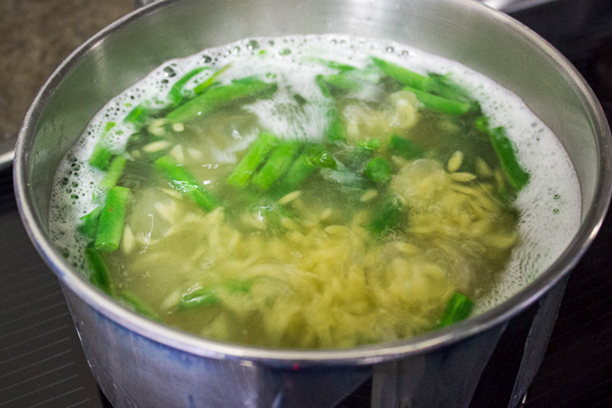 orzo and beans boiling in pot