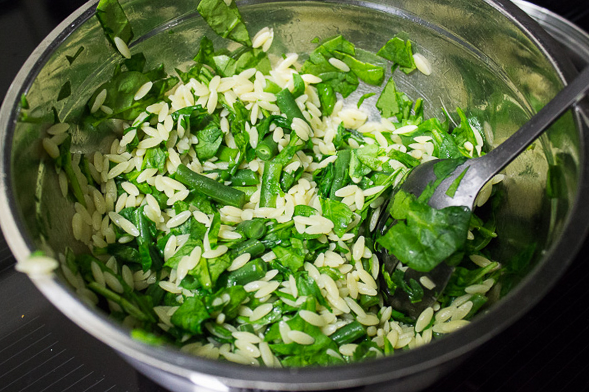 orzo and veggies in mixing bowl