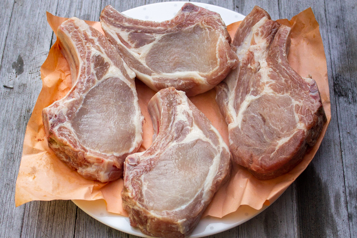 4 bone in pork rib chops on plate