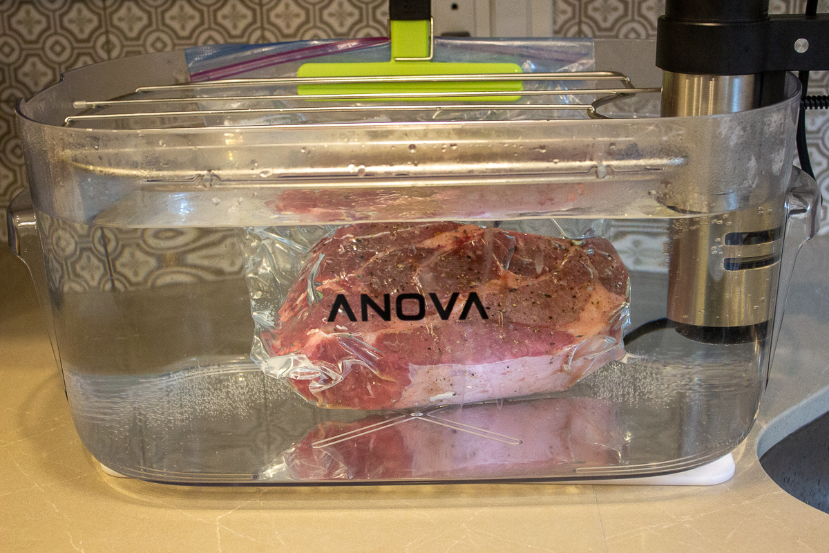 bagged chuck roast in sous vide container filled with water