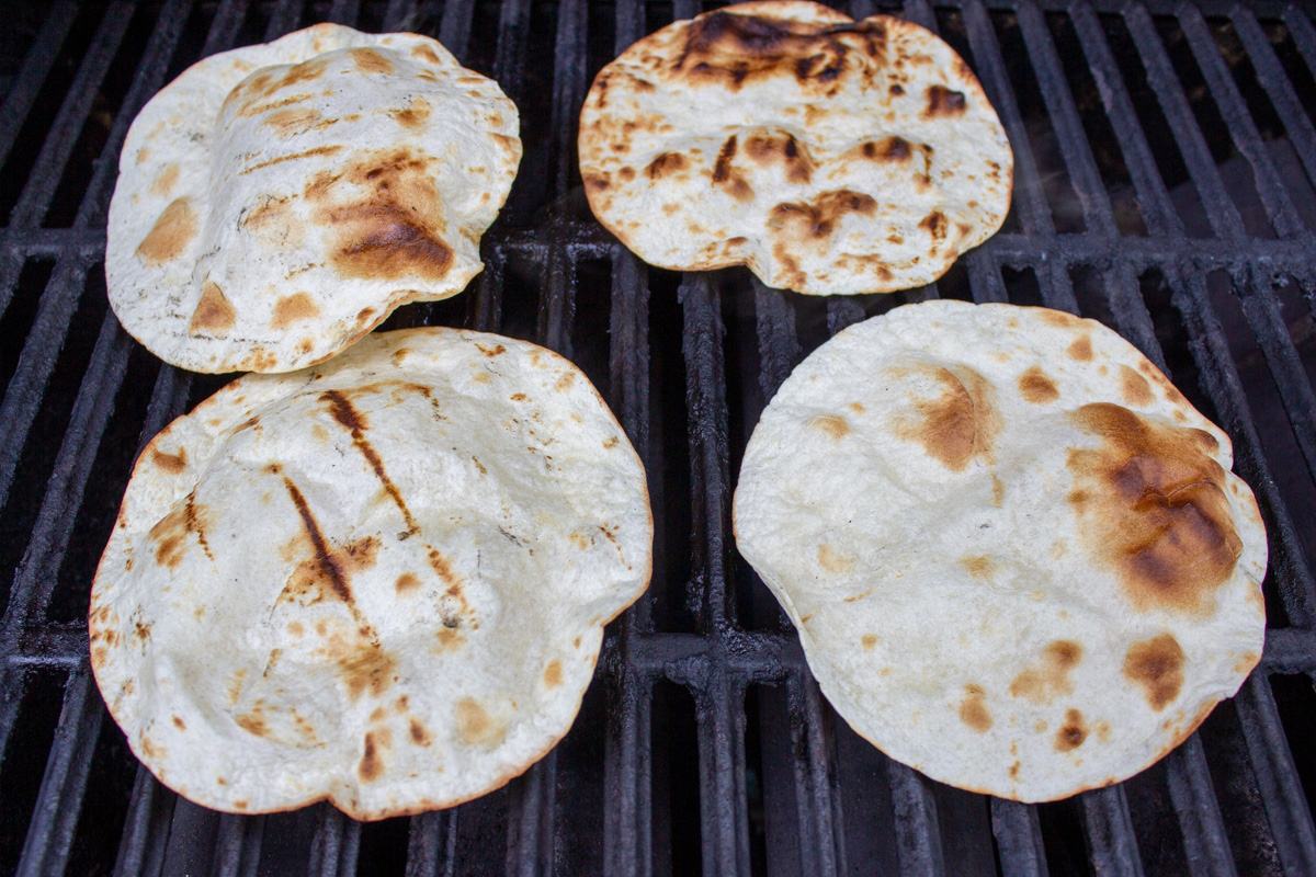 tortillas warming on grill