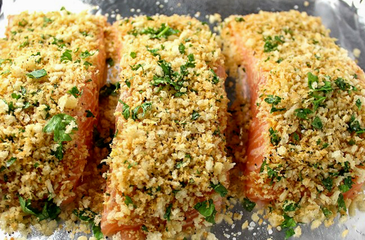 3 pieces of salmon with panko crust on pan before baking