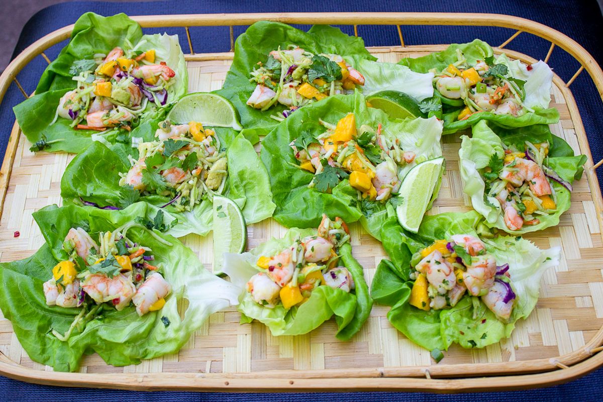 many shrimp lettuce wraps on large bamboo tray