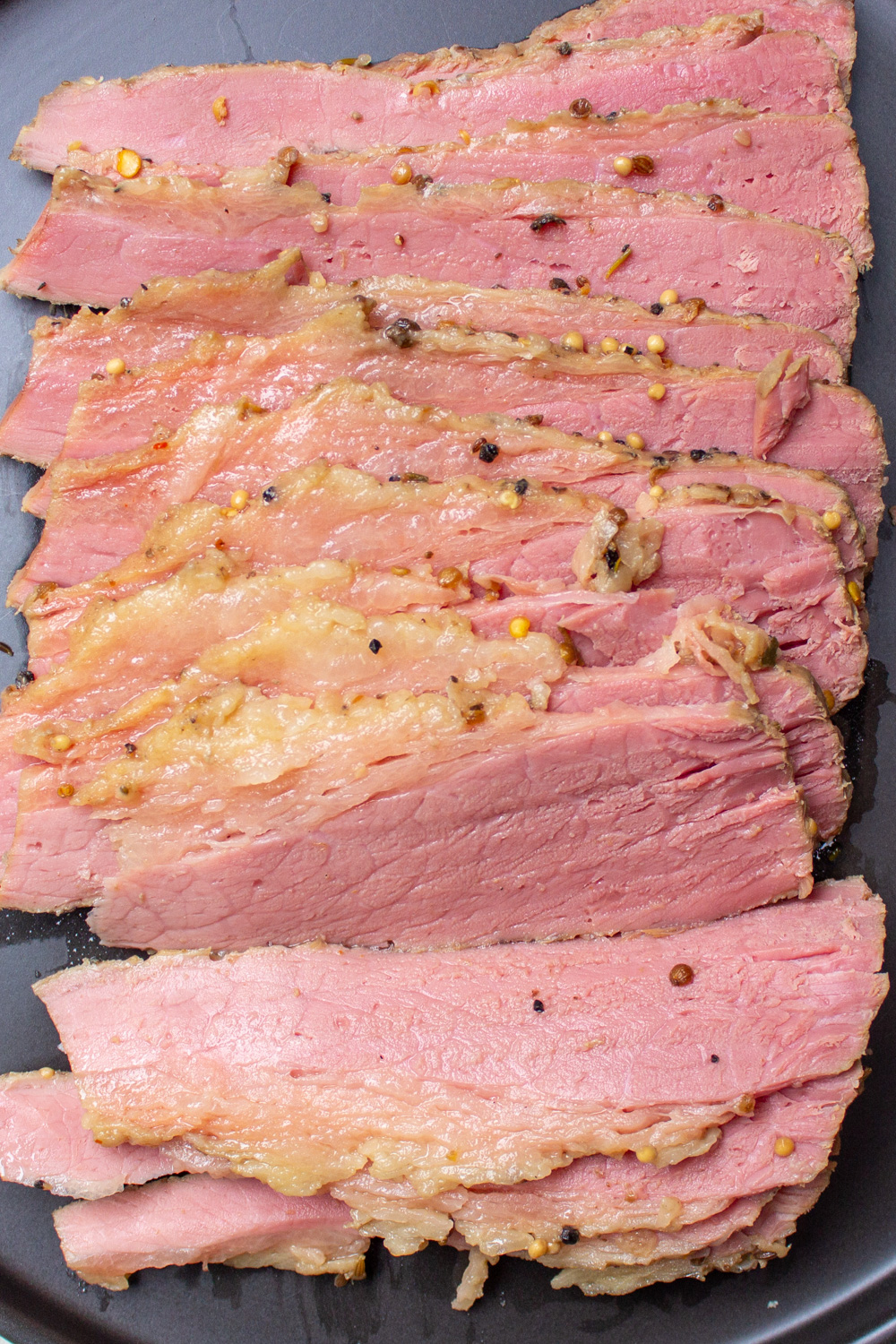 sliced corned beef on black plate 1