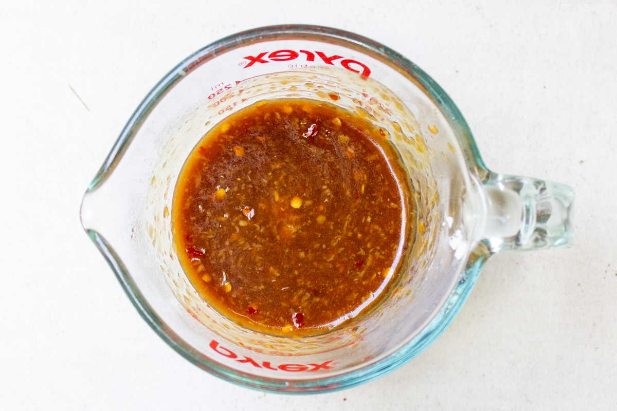 measuring cup with sauce ingredients mixed together