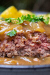 half sous vide hamburger steak on plate with onion gravy p