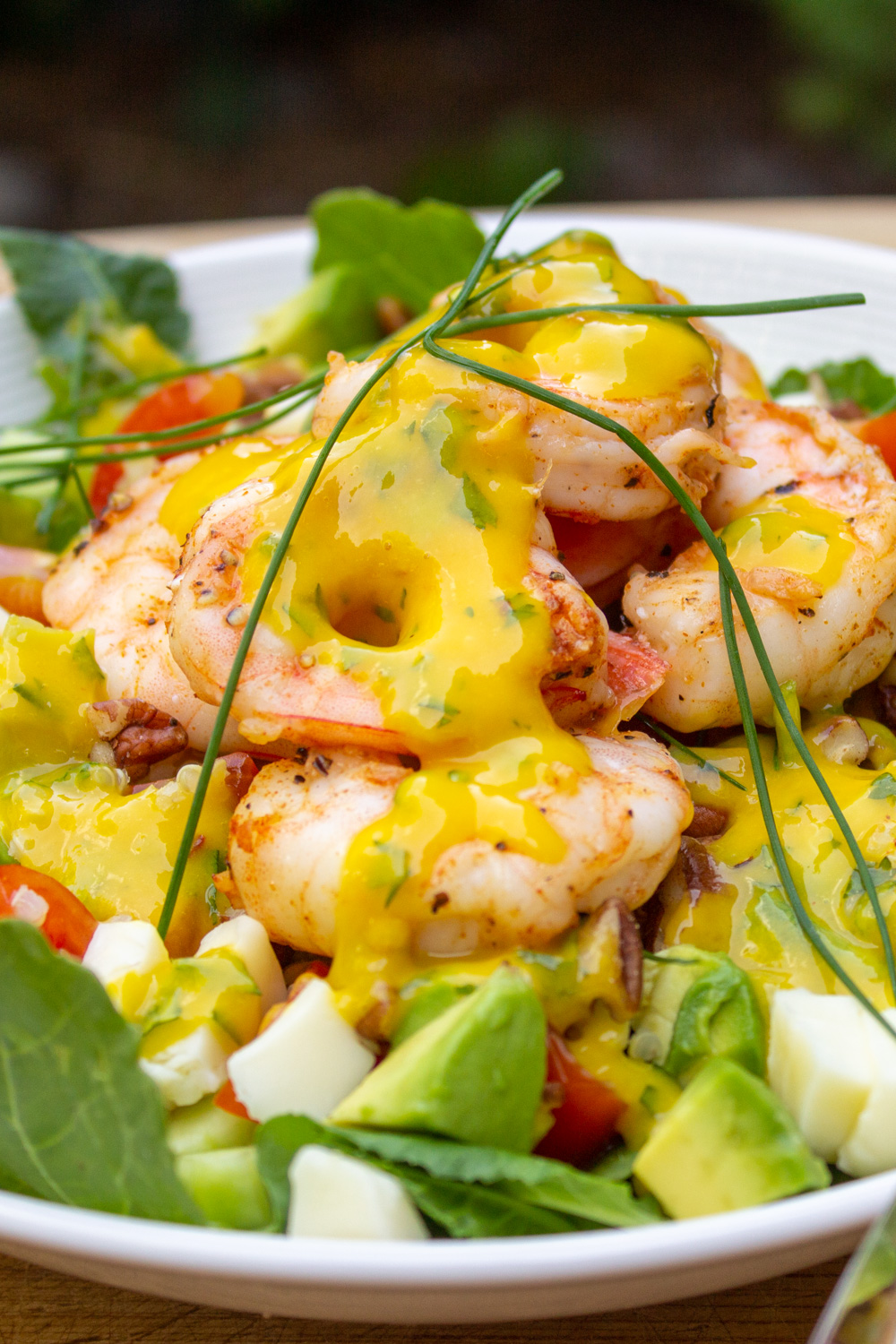 salad with shrimp and mango dressing on top