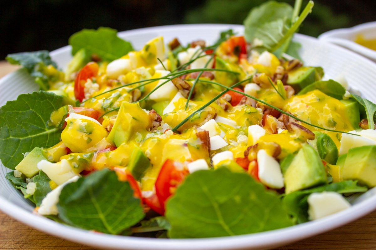 salad topped with mango dressing in bowl