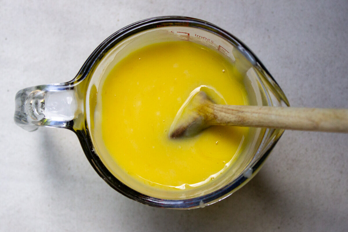 tempered eggs and pudding mixture in measuring cup