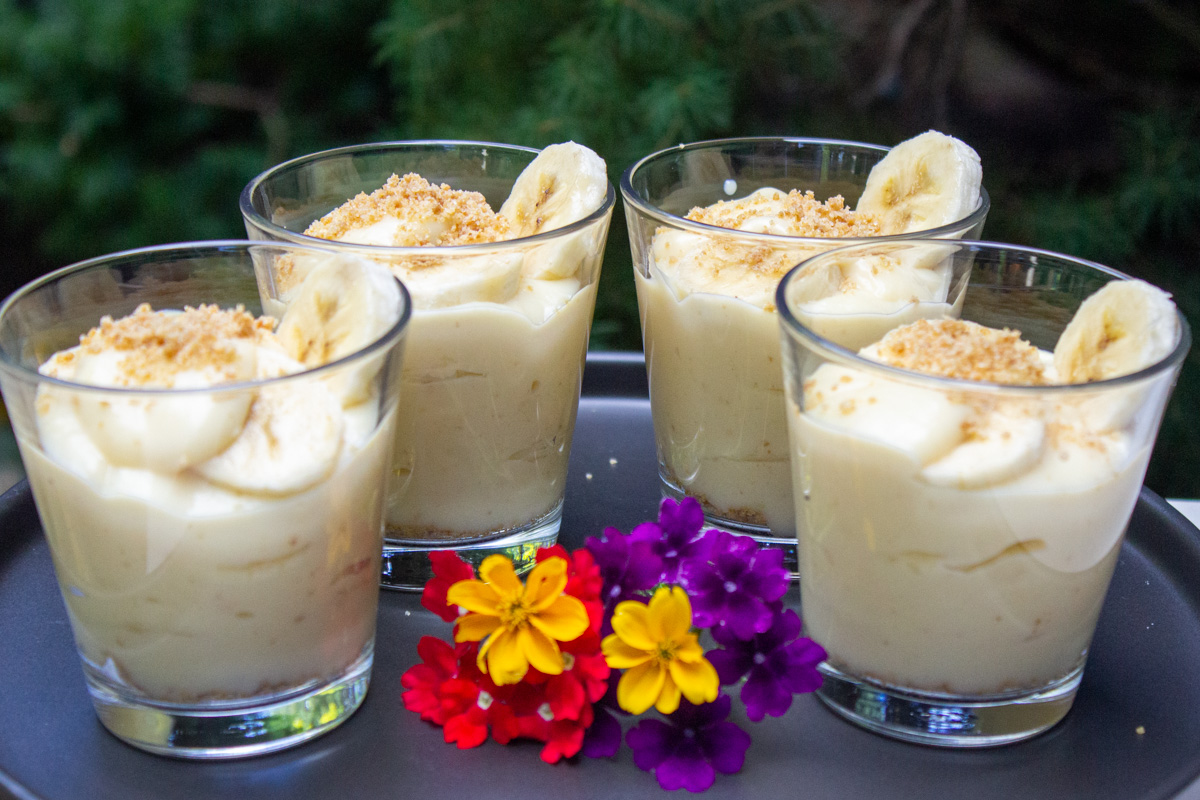 4 banana pudding cups with baby flowers in front
