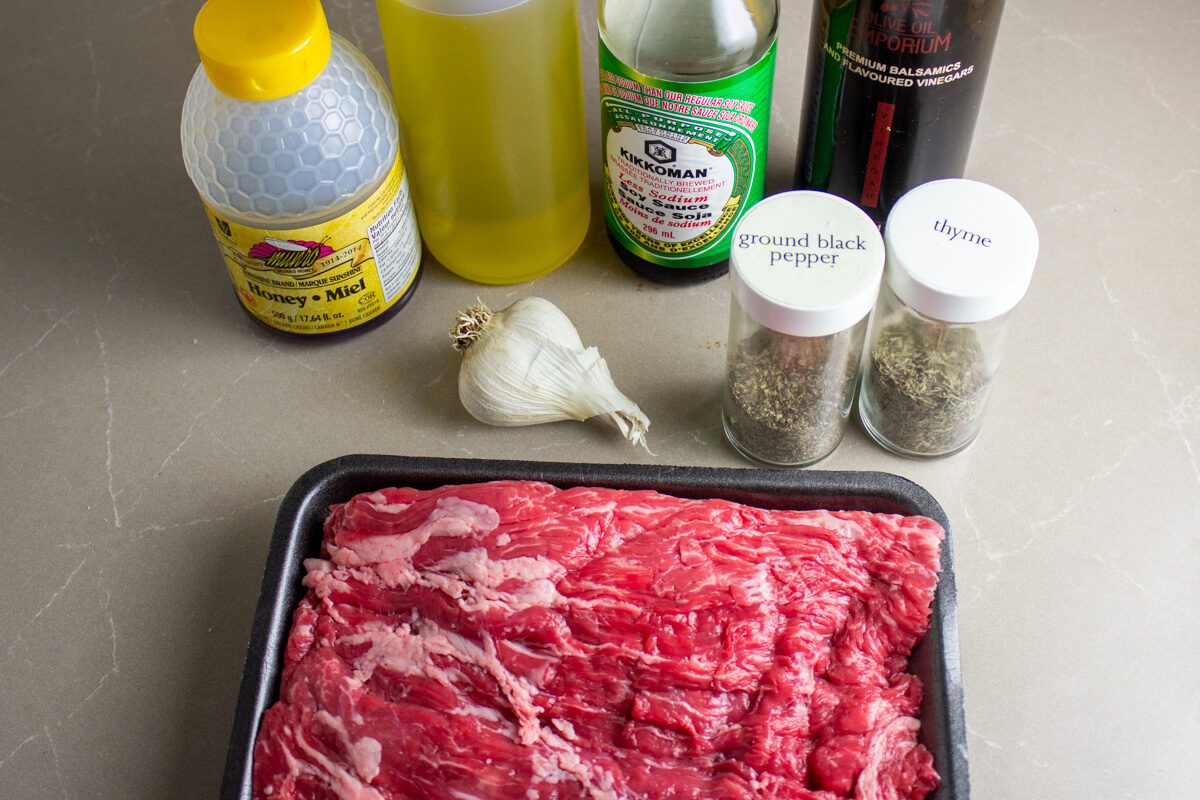 raw flank steak, garlic, honey, balsamic, soy sauce, oil, thyme,, pepper