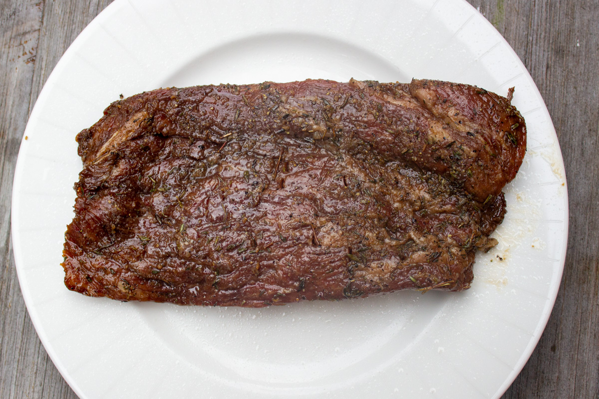raw marinated flank steak on plate