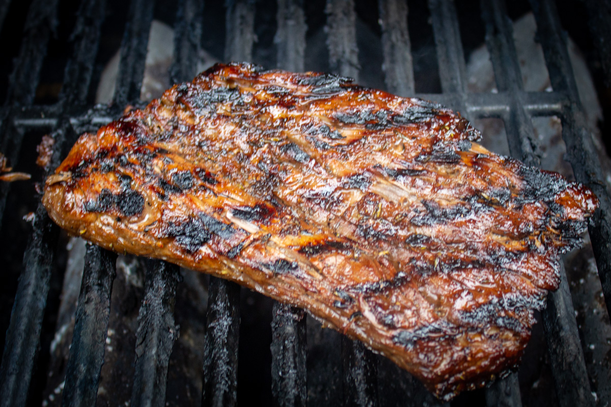 flank steak charring on grill