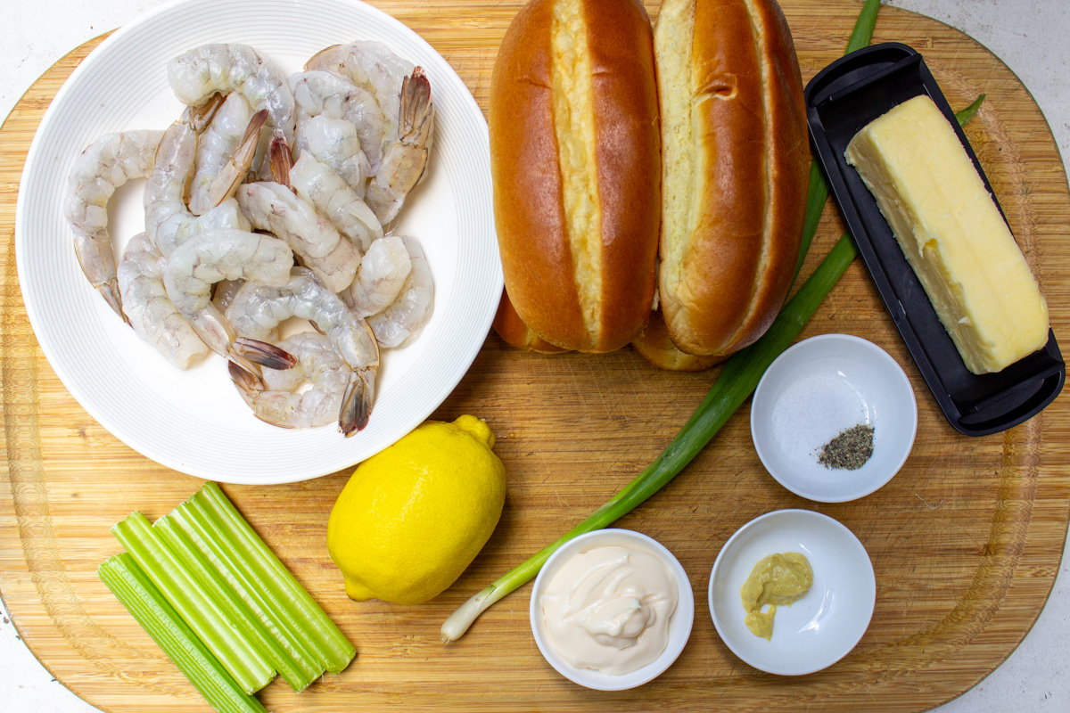 raw shrimp in bowl, mayo, Dijon, salt, pepper, celery, lemon, green onion, 4 hot dog rolls