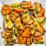 grilled sweet potatoes, apples and onions on plate
