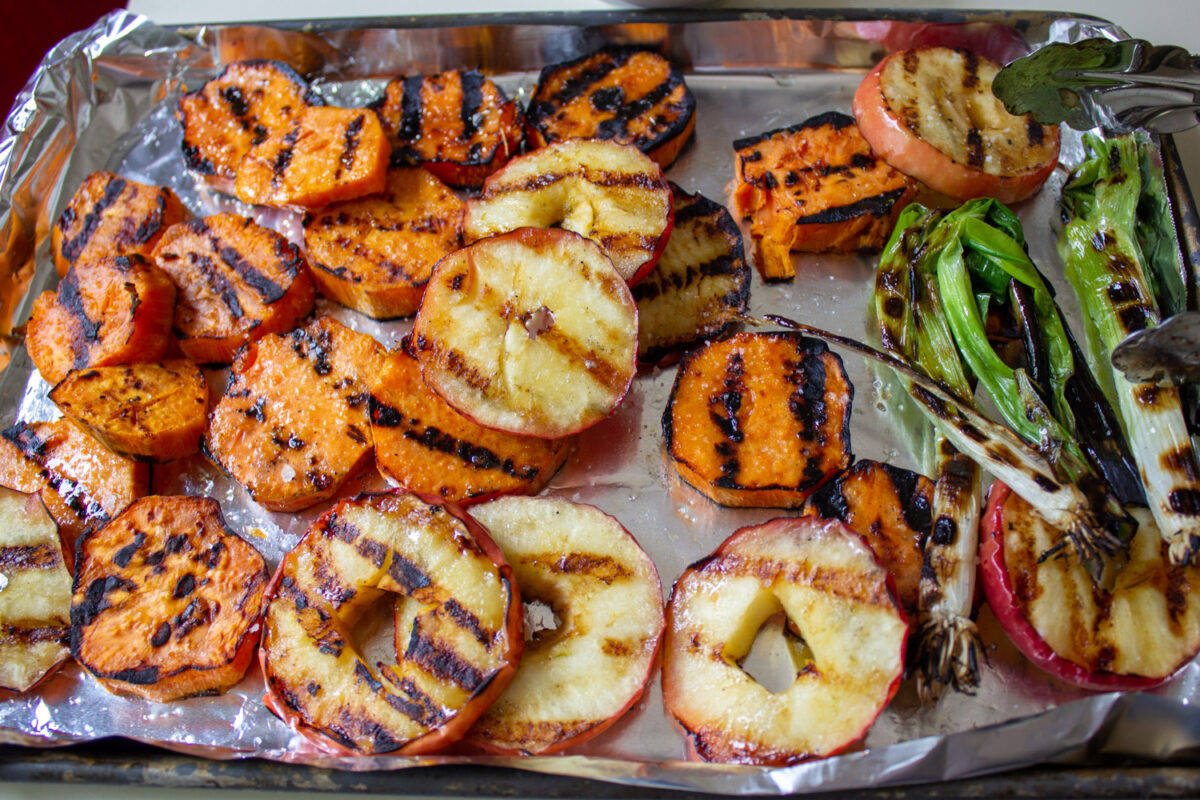 grilled apples, sweet potato slices and green onions on foiled pan