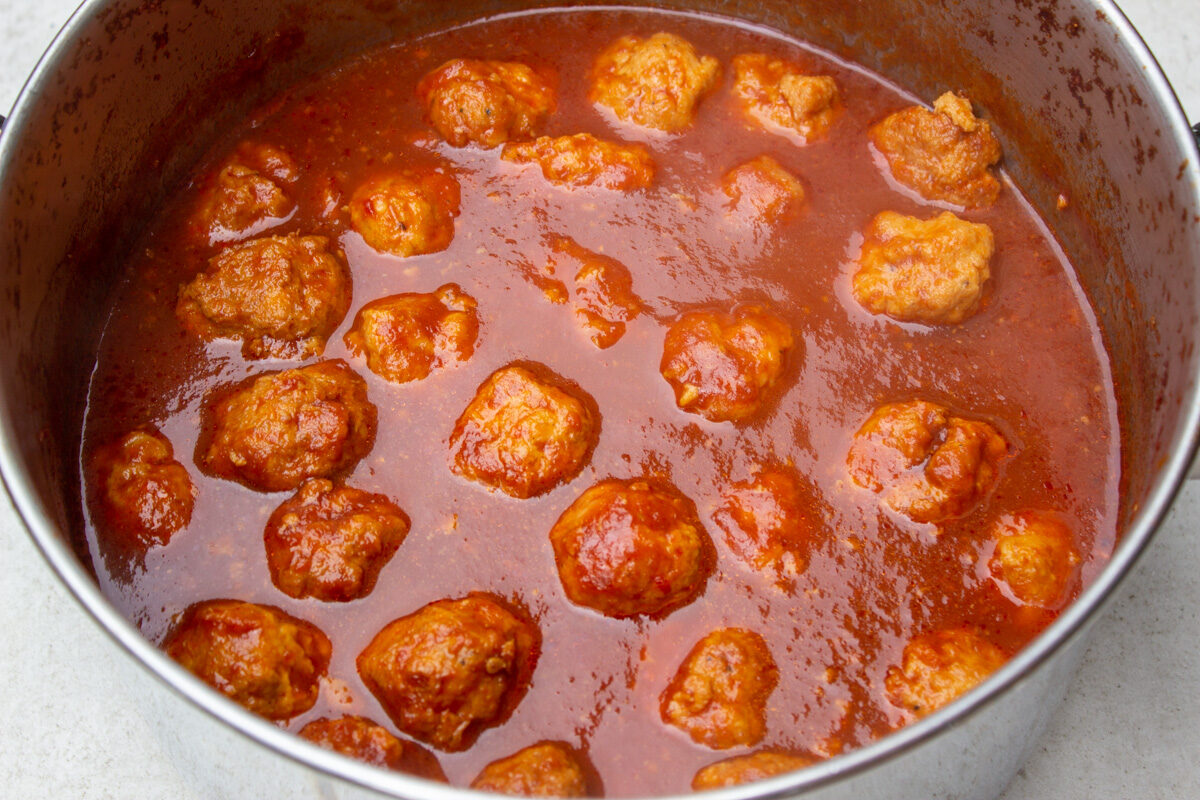 finished sweet and sour meatballs in pot.