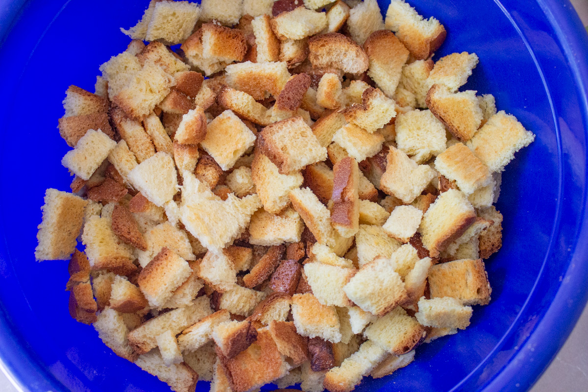 toasted bread cubes in large blue bowl.