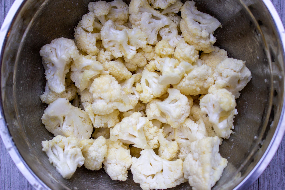 cauliflower florets coated in parmesan mixture in bowl