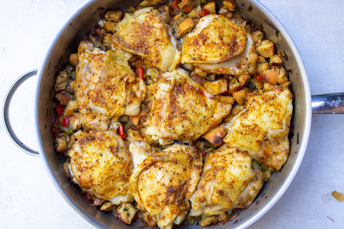 baked chicken on top of stuffing in skillet