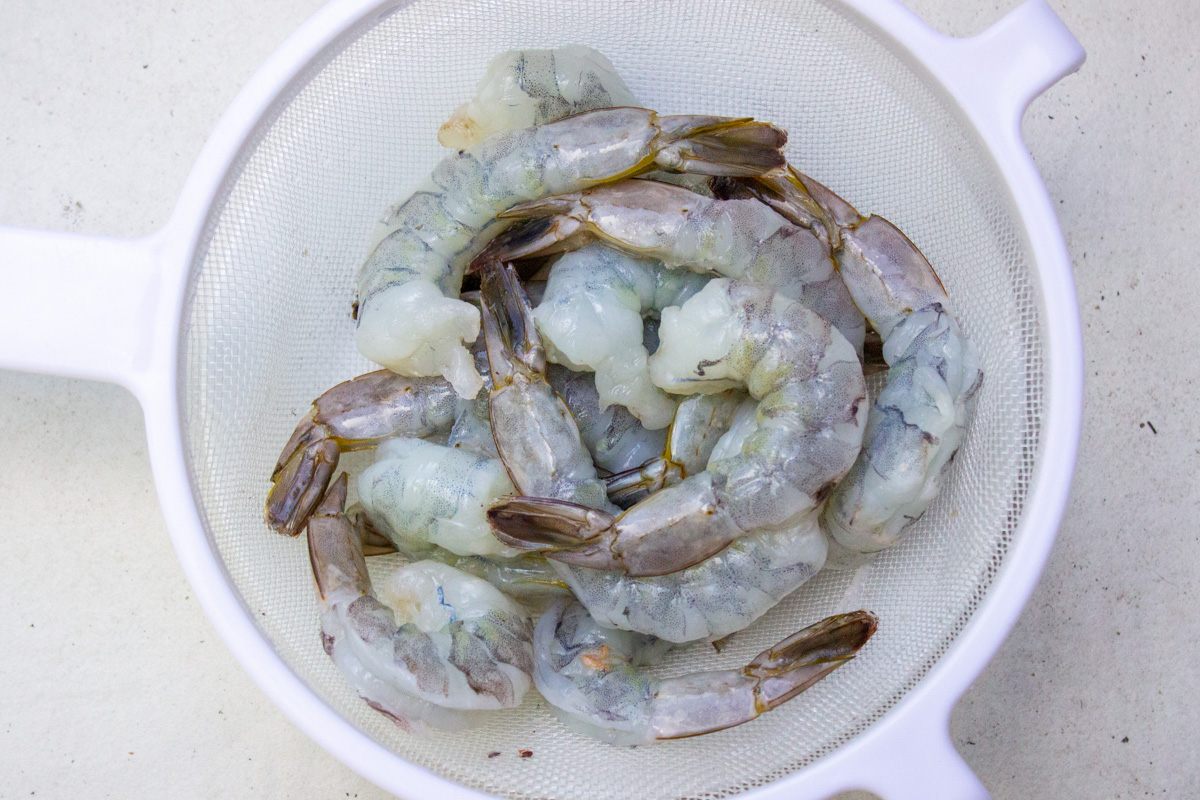 raw shrimp in colander.