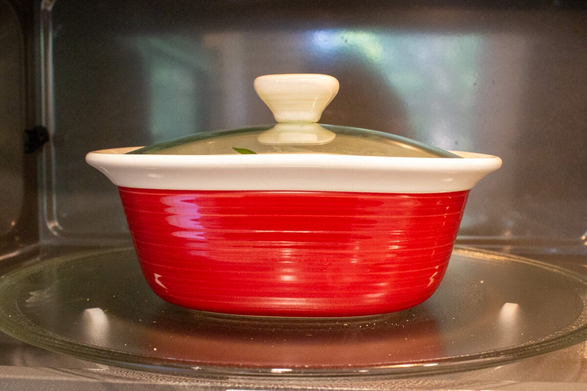red covered dish in microwave.