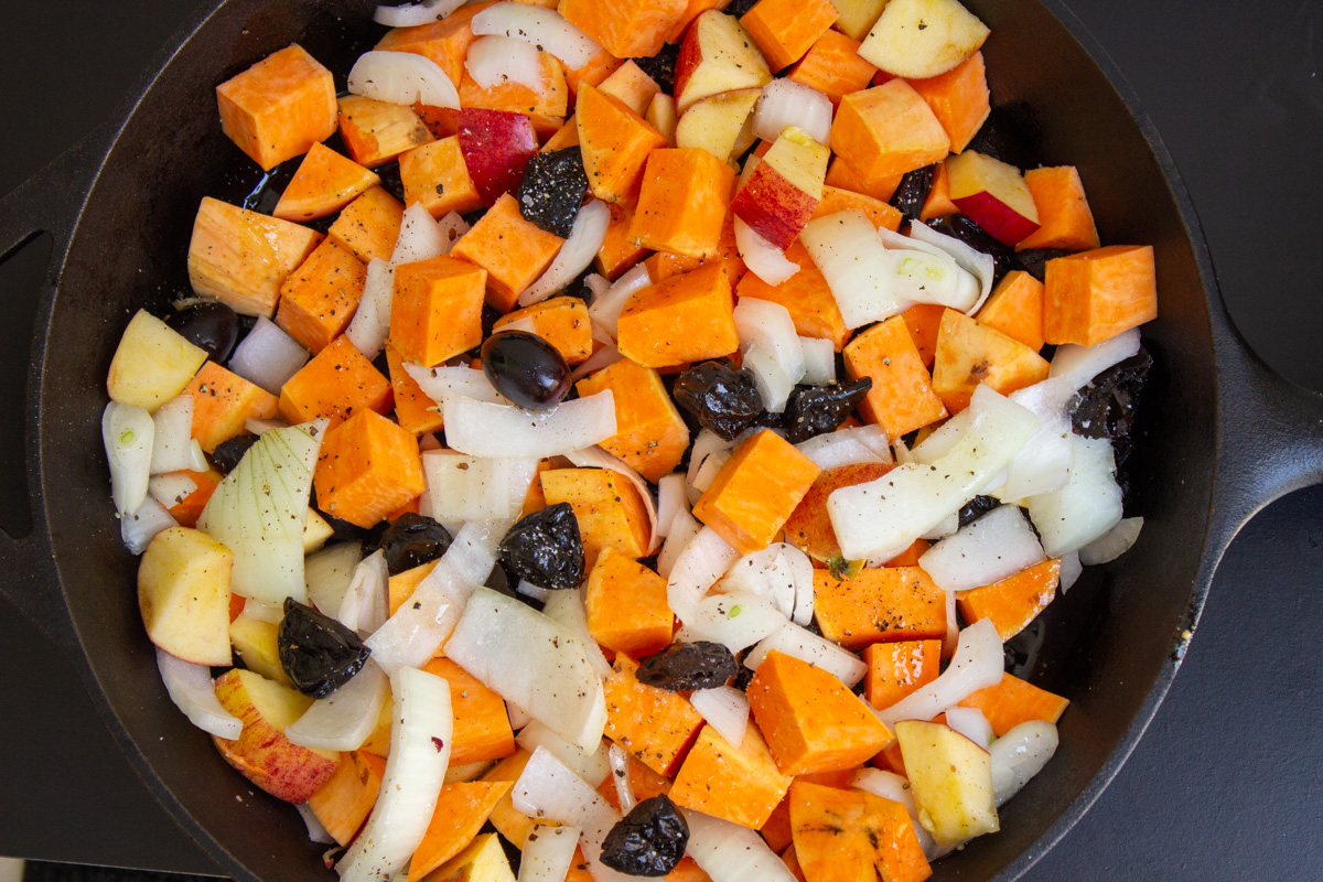 chopped veggies and fruit in skillet uncooked