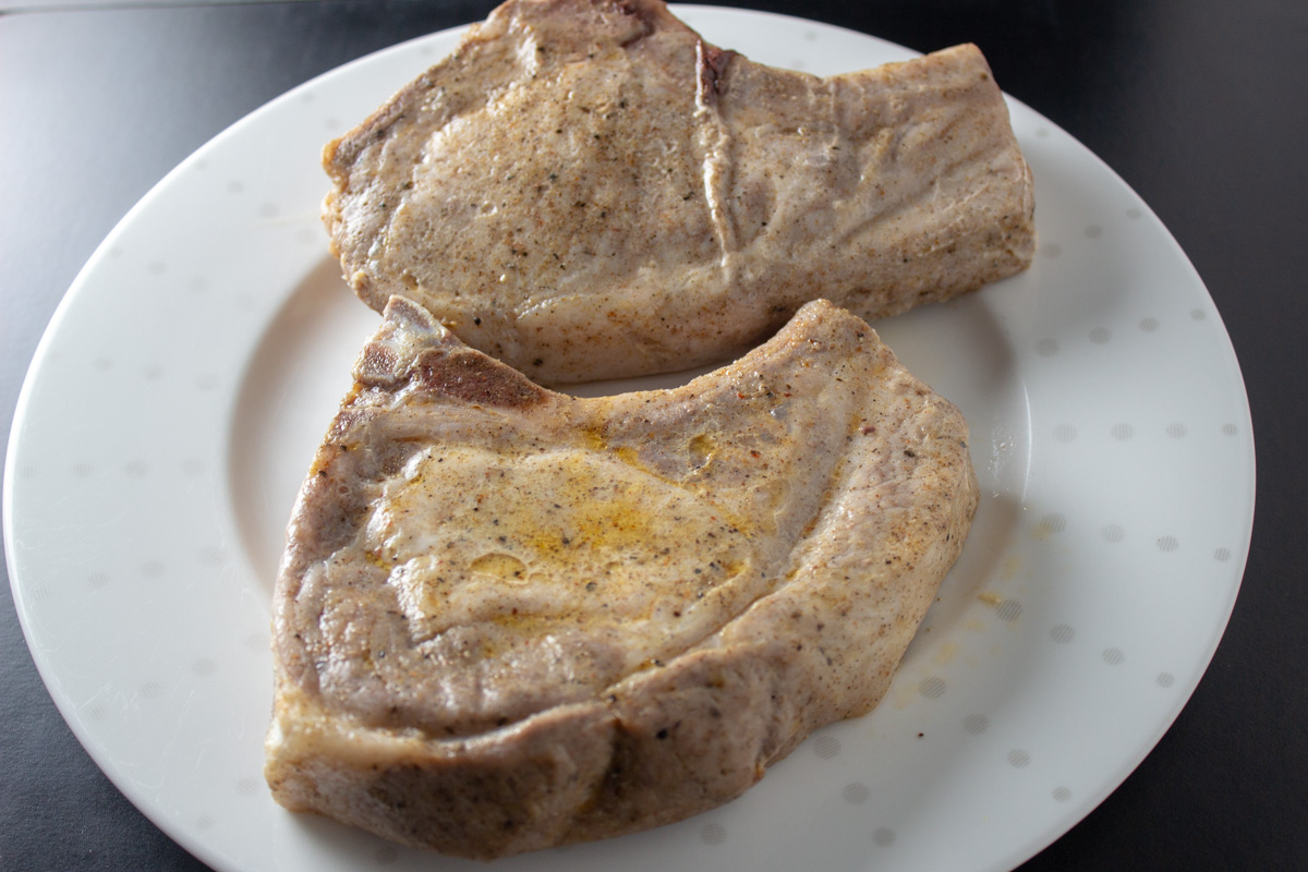 2 pork chops after sous vide cooking on plate