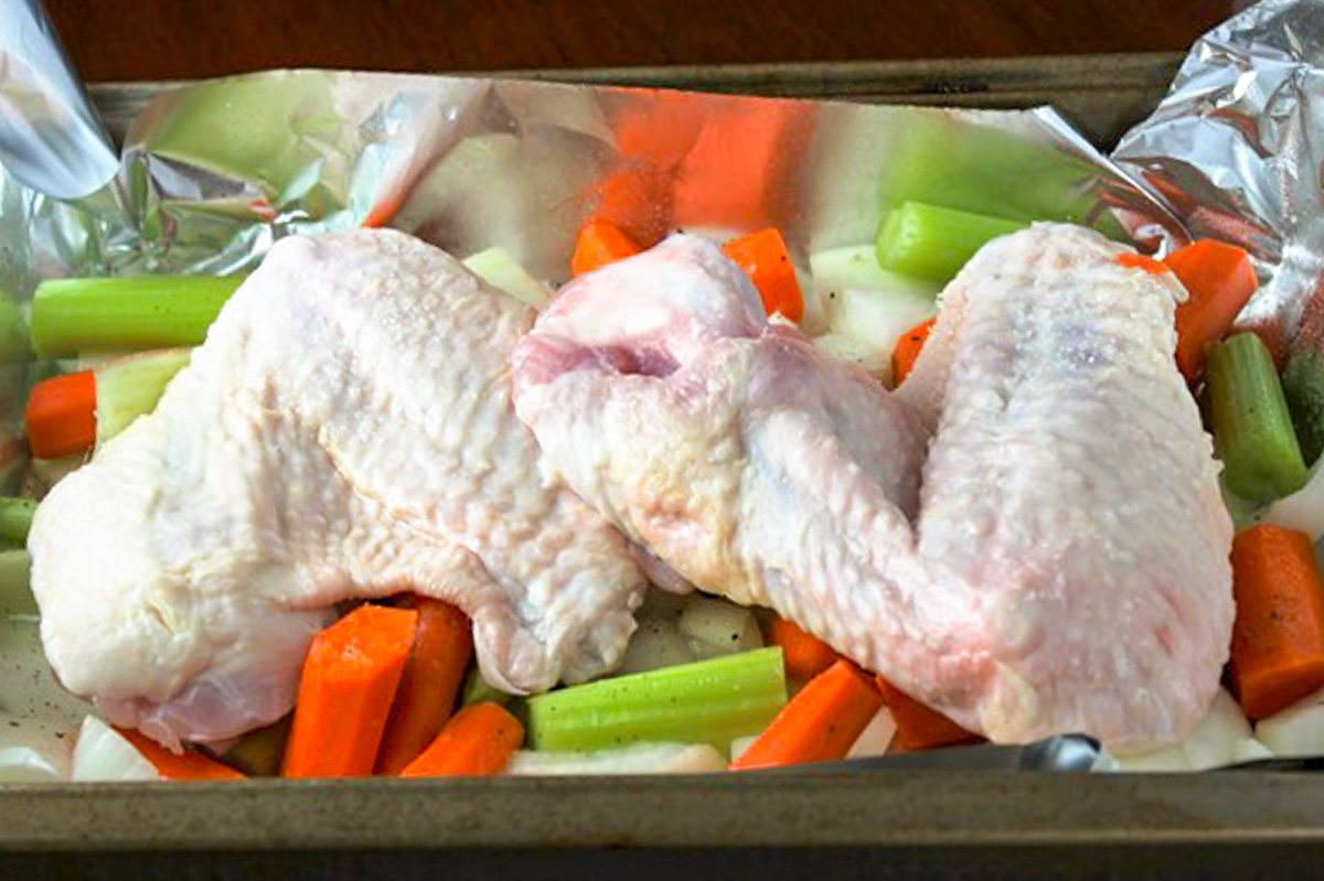 turkey wings, carrots, onions, celery in roasting pan