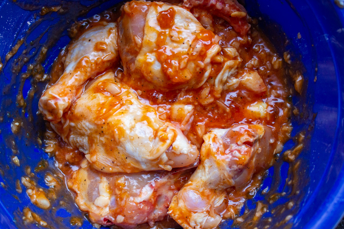 chicken and sauce in mixing bowl
