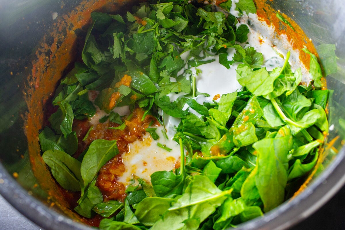 baby spinach, cilantro, coconut milk added to cooked lentil soup in instant pot