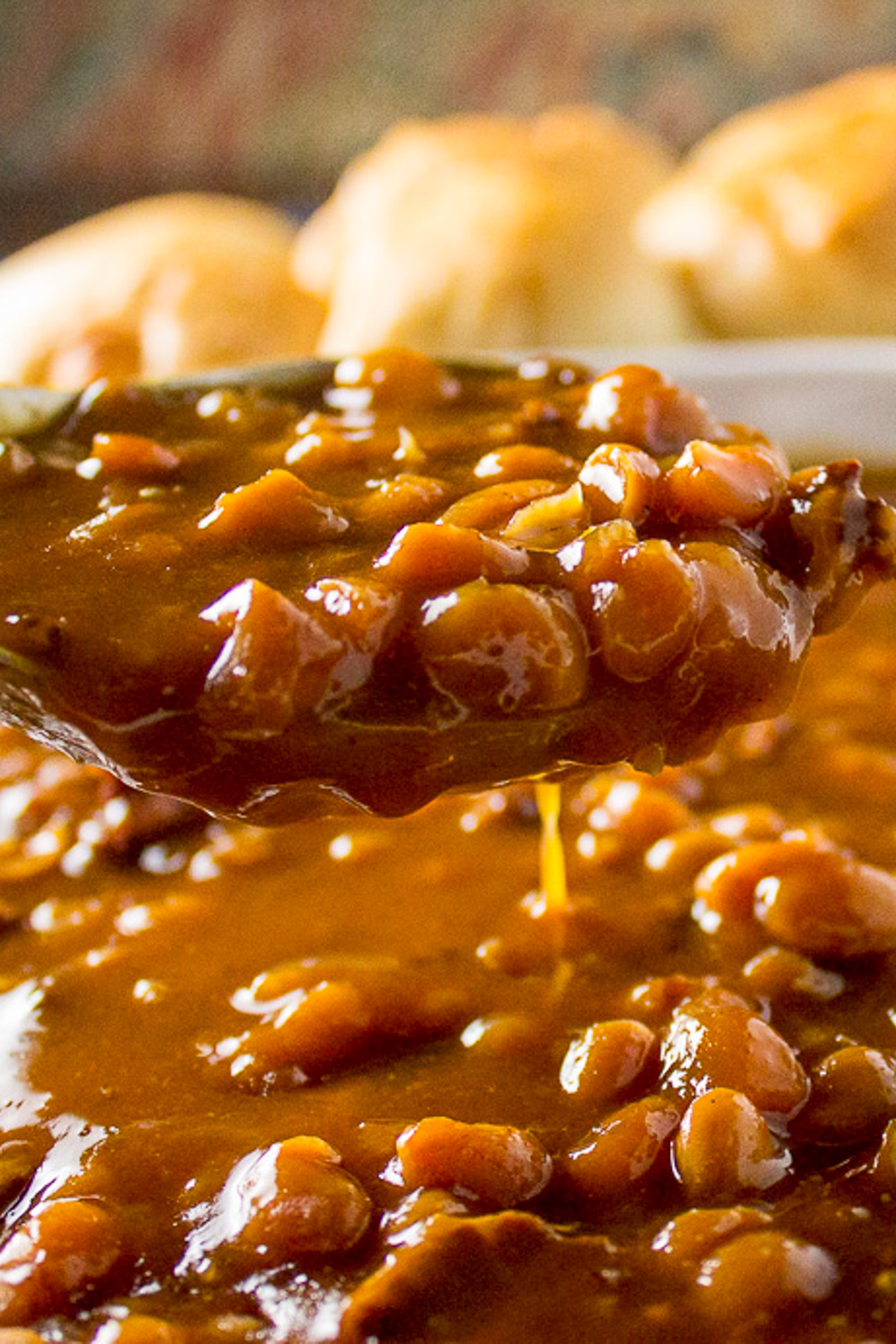 spoonful of baked beans over pot of baked beans.