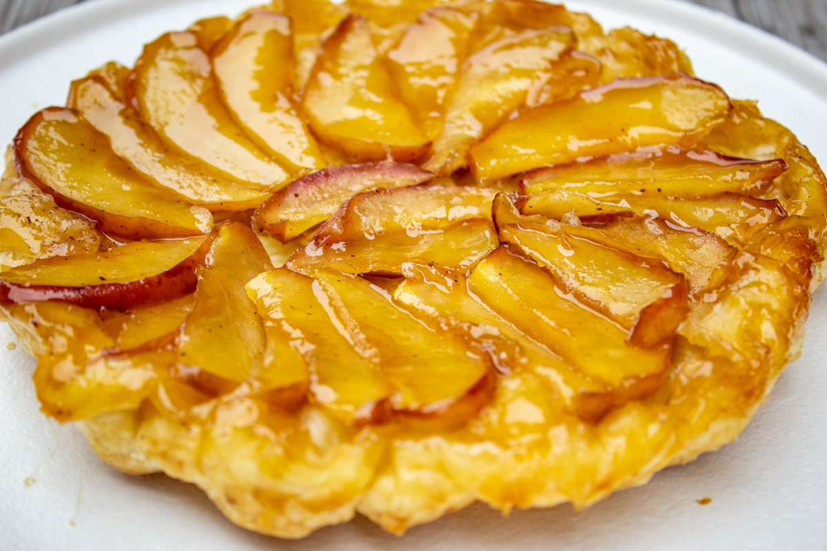 puff pastry apple tart inverted on plate