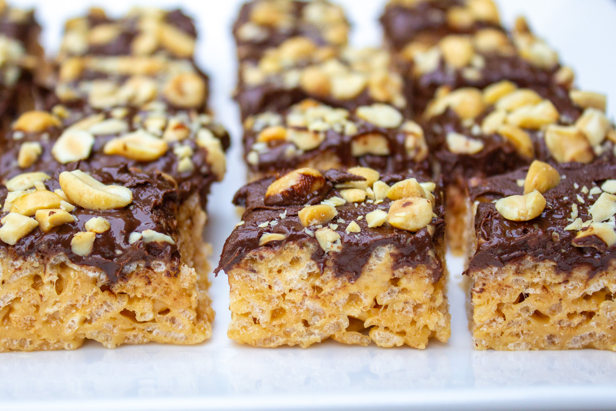 peanut butter rice krispie squares lined up in rows on plate