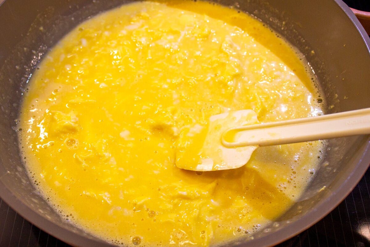 slightly thickened eggs stirred in skillet with rubber spatula