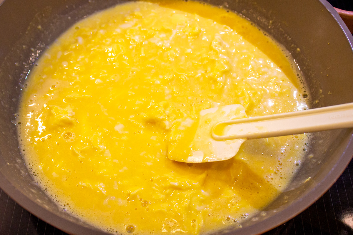 slightly thickened eggs stirred in skillet with rubber spatula
