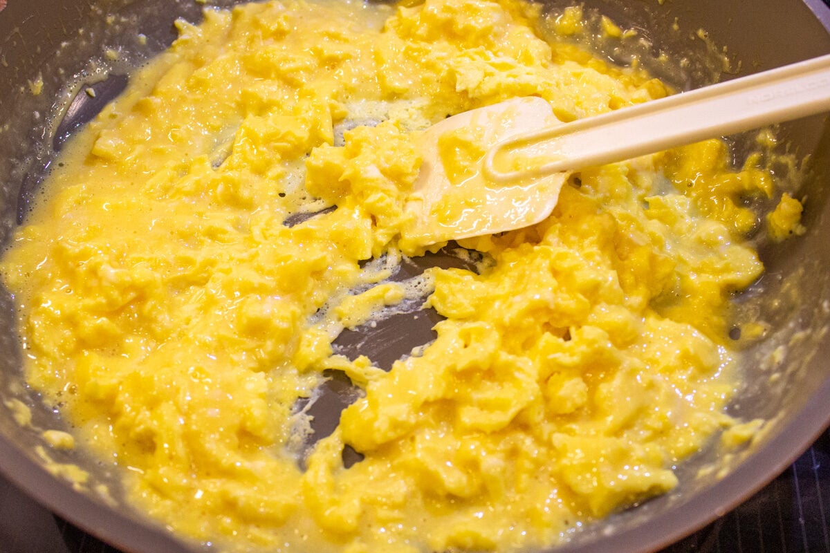 scrambled eggs in skillet with spatula