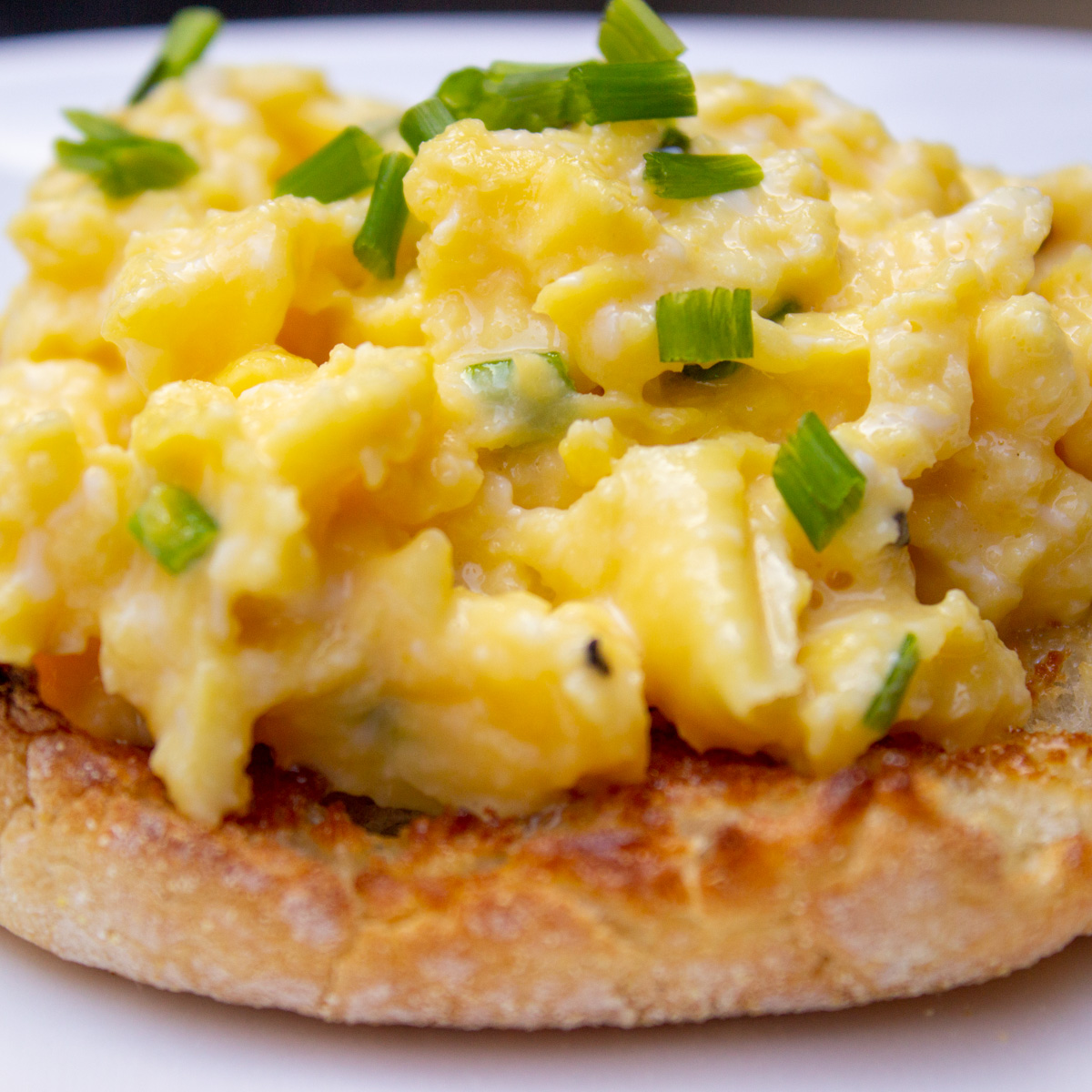 scrambled eggs on english muffin on plate