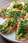 pieces of trout topped with herb lemon mixture on plate